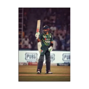 Babar Azam celebrates scoring a century, displaying his bat towards the audience, perfect for wall poster decoration ideas.