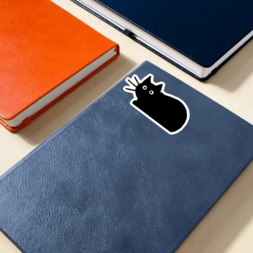 A cute black cat sticker ideal for laptops, diaries, bottles, and more, perfect as an adorable and charming gift.