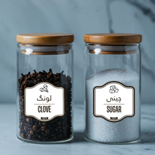 Glass jars with bamboo lids featuring pantry labels for clove and sugar, labeled in both English and Urdu, perfect for spice and kitchen storage.