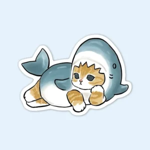 A sticker featuring a playful cat dressed in a shark costume, titled "Shark Cat Sticker."