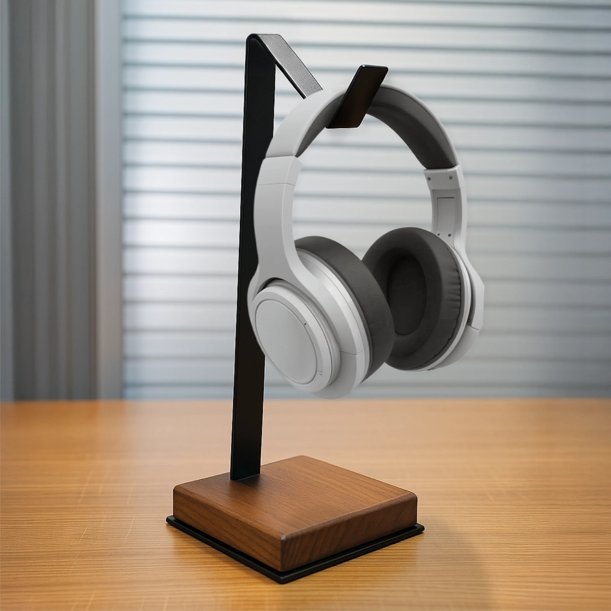 L Shaped Headphone Stand with a sleek black metal frame and premium wooden base holding white over-ear headphones on a wooden desk, showcasing a minimalist and modern workspace design.