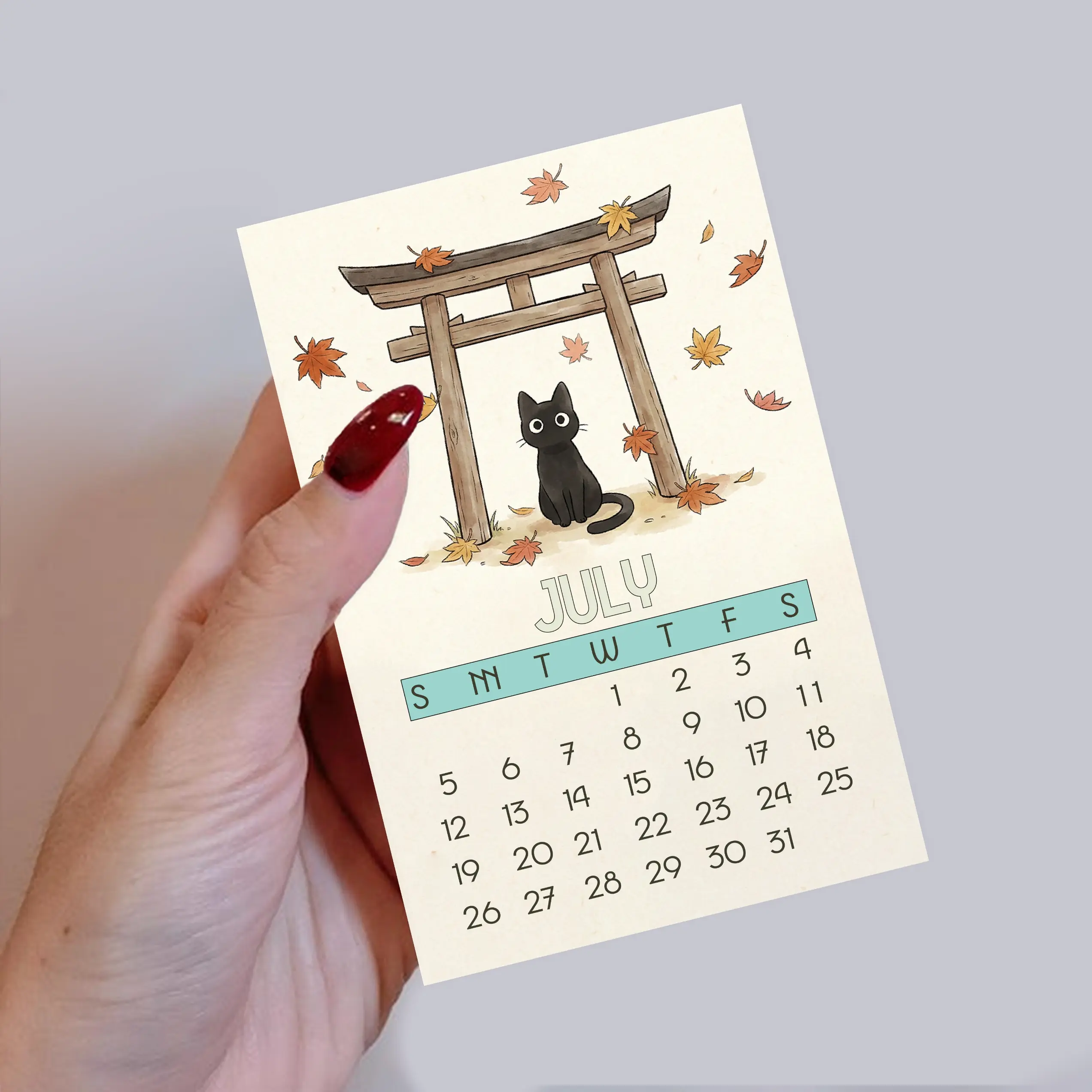 Cozy Cats 2026 Mini Desk Calendar in hand