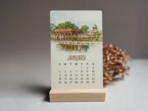 Nostalgic Lahore 2026 Mini Calendar January card displayed on a wooden stand, featuring a watercolor painting of Shalimar Gardens.
